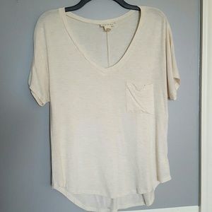 Loose and comfy cream short sleeved shirt.